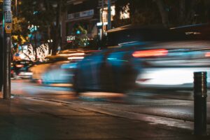 Blurred vehicle motion on a Phoenix, AZ, street at night, representing traffic-related injuries