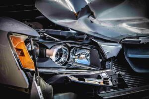 Close-up of damaged car headlight and bumper after collision, showcasing in Phoenix, AZ